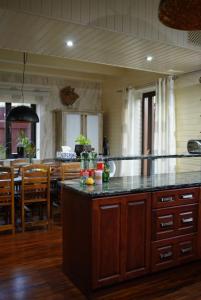 a kitchen with a counter and a dining room at CHALET RaJ in Gelnica