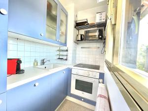 a small kitchen with a sink and a stove at Le Castel 1 C.L.S Deauville in Deauville