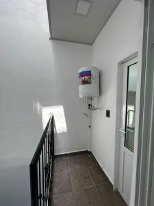 a stairway with a water heater on a white wall at EDIFICIO BETEL in Salvador Mazza