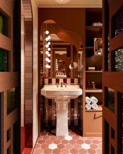 a bathroom with a sink and a mirror at Château des Fleurs - Hôtel & Spa - Paris Champs-Elysées in Paris