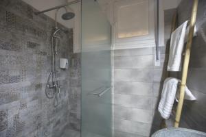 a bathroom with a shower with a glass door at Apollonos Amalia one bedroom in Athens
