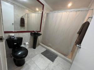 a bathroom with a toilet a sink and a shower at Pista Q hostel and apartments in Oranjestad