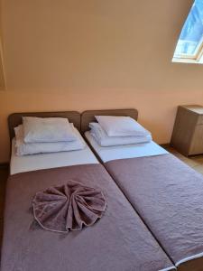 two beds in a room with a bow on them at Готель АС Ясіня in Yasinya