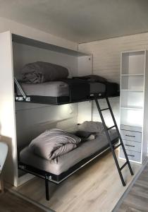 two bunk beds with pillows on them in a room at Appart Les Carroz in Les Carroz d'Araches