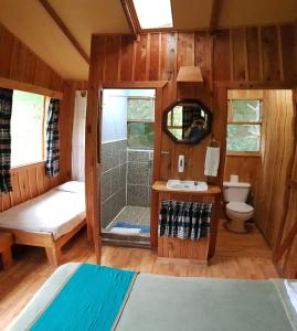 a small bathroom with a shower and a toilet at Finca Terra Viva in Monteverde Costa Rica