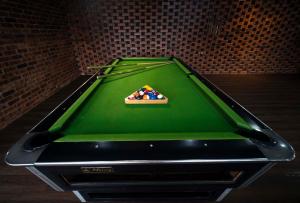 a green felt pool table with a cue ball on it at Genting View Resort GVR Kempas in Genting Highlands +54 photos