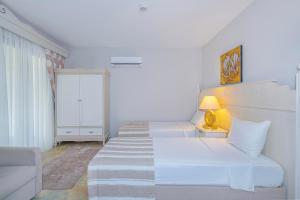 A bed or beds in a room at Alya Villa Butik Hotel