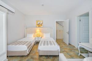 A bed or beds in a room at Alya Villa Butik Hotel