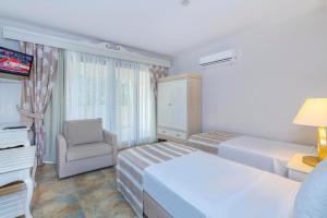 A bed or beds in a room at Alya Villa Butik Hotel