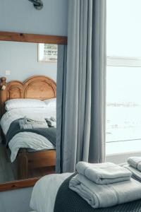 A bed or beds in a room at The Nook, Portstewart