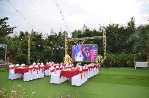 um grupo de cadeiras vermelhas e brancas em frente a um ecrã em Hoa Và Đá Ninh Binh em Ninh Binh