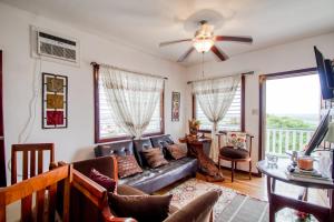 a living room with a couch and a ceiling fan at Mattea Vacation House at Bella Vue Estate in Georgeville