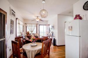 a kitchen and dining room with a table and a refrigerator at Mattea Vacation House at Bella Vue Estate in Georgeville