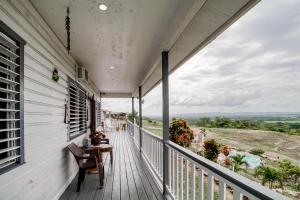 a porch with a table and a view at Mattea Vacation House at Bella Vue Estate in Georgeville
