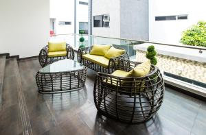 a balcony with wicker chairs and a table at Rushmore - Standard Room in Lagos