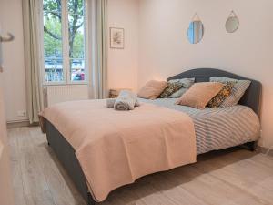 a bedroom with a bed with a cat on it at L'annexe Clermont Ferrand in Clermont-Ferrand