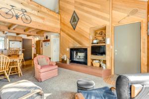 a living room with a fireplace and wooden walls at 7 Hare Lane in Sunriver