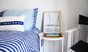 a bedroom with a bed with a picture of a sailboat on it at Nautic in Quarteira +85 photos