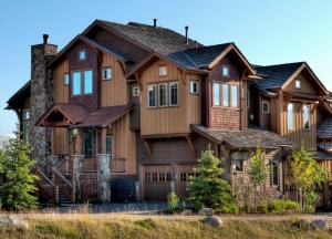 a large wooden house with a gambrel at The Porches in Steamboat Springs
