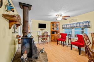 a living room with a fireplace and a table and chairs at Fanci's Hideout in Atlantic Beach