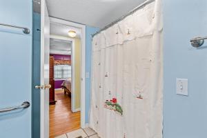 a bathroom with a shower curtain in a room at Fanci's Hideout in Atlantic Beach
