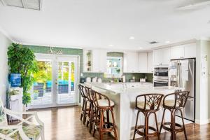 a kitchen with a large island with bar stools at Sea Salt Harbor in Marathon