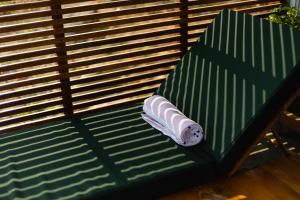 a roll of sushi sitting on a green bench at Casa Jaali in Patnem