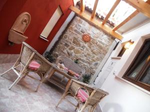 a room with two chairs and a stone fireplace at B&B Tra Monti e Mare in Ogliastro Cilento