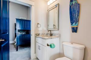 a bathroom with a toilet and a sink and a mirror at Blue Wave in Myrtle Beach