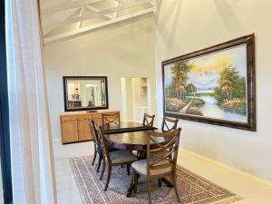 a dining room with a table and chairs at Sasavona Cottage - 349 Vaal de Grace Golf Estate in Parys