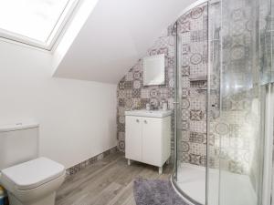 a bathroom with a toilet and a shower at Sanibel in Christchurch