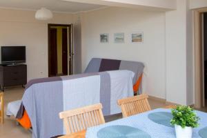 a room with a bed and a table and chairs at Beachfront Villa Possidi by Halkidiki Villas in Possidi +19 photos