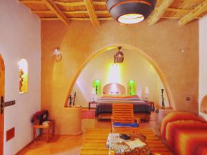 a bedroom with a bed in a room with an archway at La Perle Du Dades in Boumalne +229 photos