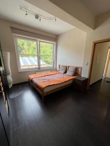 a bedroom with a bed and a large window at Loft spacieux dans une ancienne beurrerie avec parking gratuit in Theux