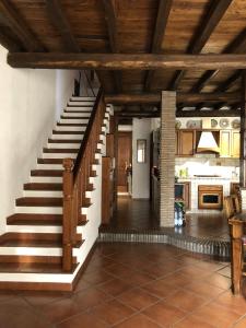 a staircase in a kitchen with wooden ceilings at Verso Sud in Sutri