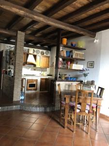 a kitchen with a table and chairs in a room at Verso Sud in Sutri
