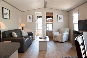 a living room with a couch and a chair at Vine Ridge Resort in Niagara on the Lake