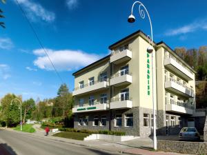 a building on the corner of a street at Ośrodek Wczasowy Paradise in Krynica Zdrój