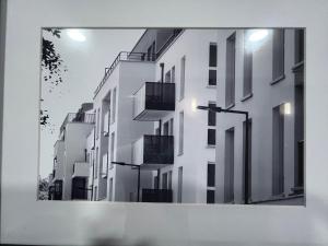 a picture of a white building with windows at Chambre individuelle dans un appartement à 37 de champs élysées in Sartrouville