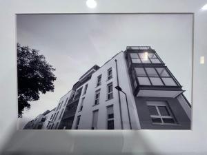 a tall white building with windows on the side of it at Chambre individuelle dans un appartement à 37 de champs élysées in Sartrouville +5 photos