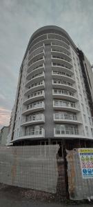a large white building in front of a building at Apartman Gavric 2 in Doboj