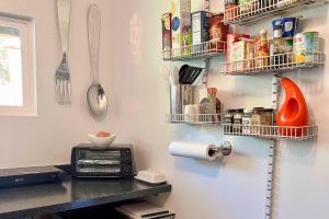 a kitchen with a counter with shelves and utensils at Modern Entertainment Getaway Off Sacramento River! in Anderson