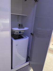 a bathroom with a sink and a white cabinet at Piraeus Cozy in Piraeus