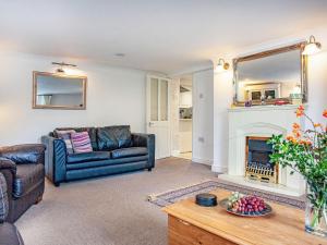 a living room with a couch and a fireplace at Westerlands Apartment in Torquay