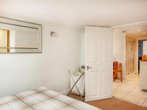 a bedroom with a bed and a mirror on the wall at Westerlands Apartment in Torquay