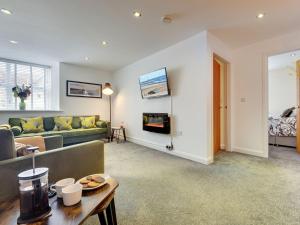 a living room with a couch and a fireplace at Heron Apartment in Berwick-Upon-Tweed