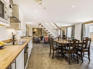 a kitchen and dining room with a table and chairs at The Stables - Uk40093 in Bryngwyn
