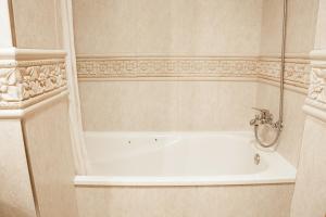 a bathroom with a bath tub and a sink at Apartamentos Carolina in Torremolinos +39 photos