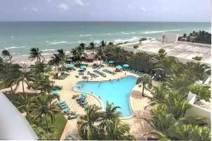 an aerial view of a resort with a pool and the ocean at Amazing Apartment on hollywood beach TIDES in Hollywood