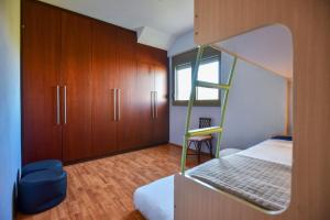 a bedroom with a bunk bed and wooden cabinets at VillaBayViewCrete in Hersonissos
